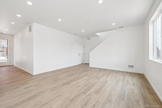 6636 N Nepal St, Aurora, CO 80019 - unfurnished living room with light wood finished floors, recessed lighting, plenty of natural light, and baseboards