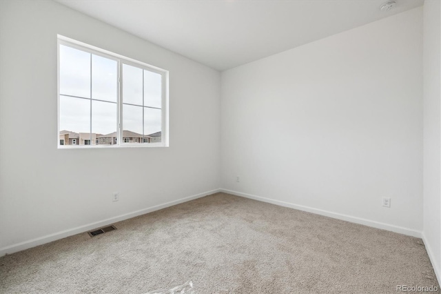 6636 N Nepal St, Aurora, CO 80019 - spare room featuring carpet floors, baseboards, and a smoke detector