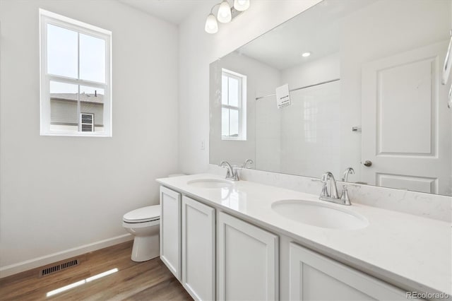 6636 N Nepal St, Aurora, CO 80019 - full bath featuring baseboards, toilet, wood finished floors, double vanity, and a shower
