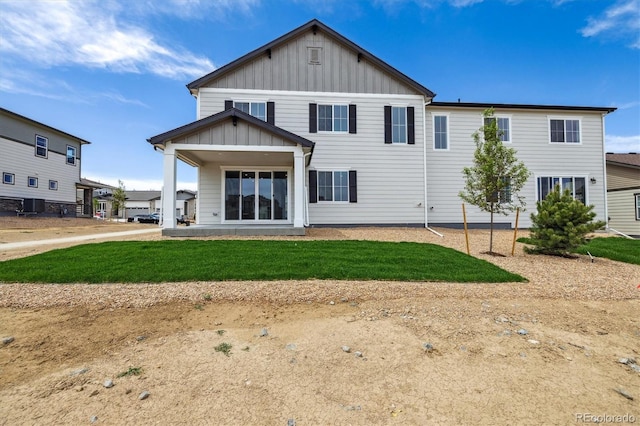 6636 N Nepal St, Aurora, CO 80019 - back of house featuring board and batten siding and a yard