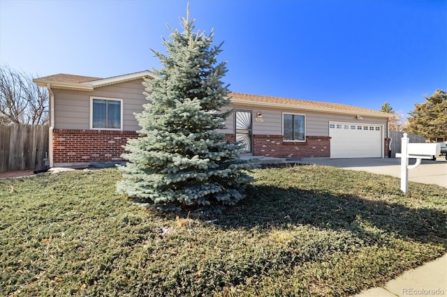 single story home featuring brick siding, a front lawn, fence, concrete driveway, and a garage