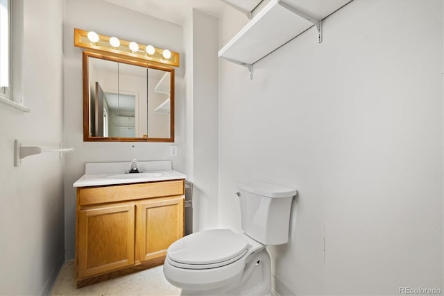 bathroom featuring toilet and vanity