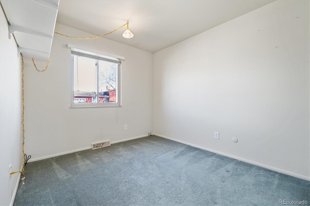 carpeted spare room with baseboards and visible vents