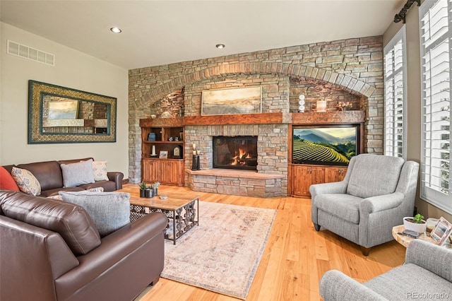 living room with a fireplace and wood-type flooring