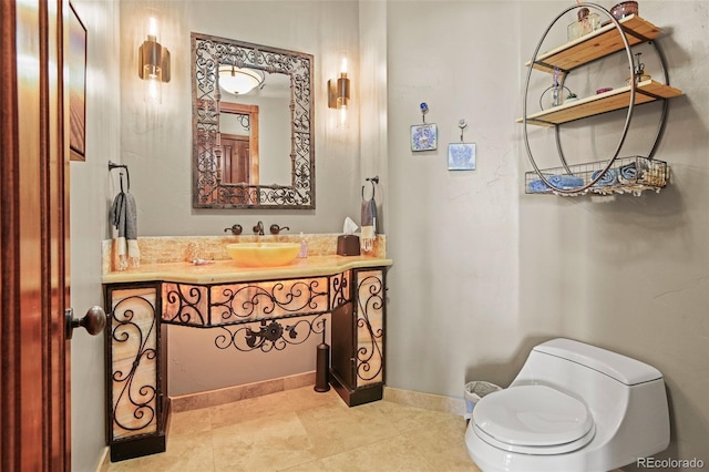 bathroom featuring tile patterned floors, vanity, and toilet