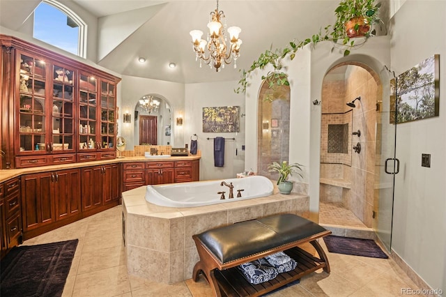 bathroom with independent shower and bath, vanity, tile patterned flooring, and a chandelier