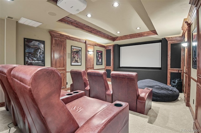 carpeted home theater with a raised ceiling