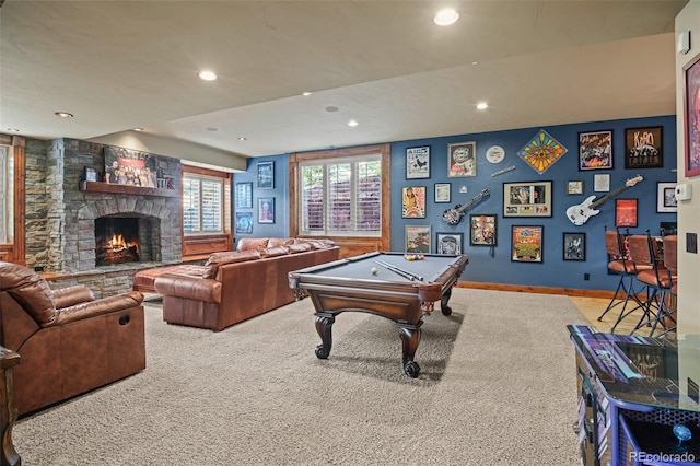 game room featuring light carpet, a stone fireplace, and pool table