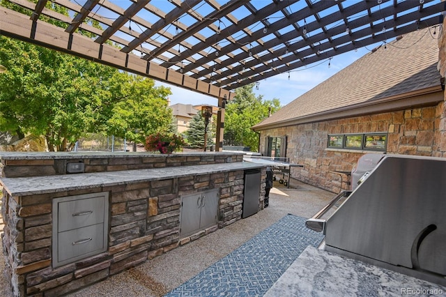 view of patio featuring area for grilling and a pergola