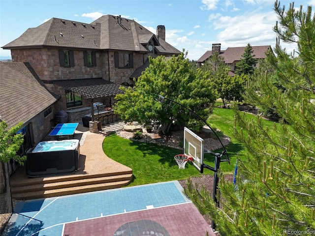 view of sport court with a lawn