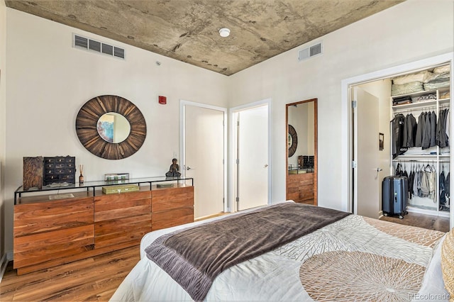 bedroom featuring wood-type flooring and a closet