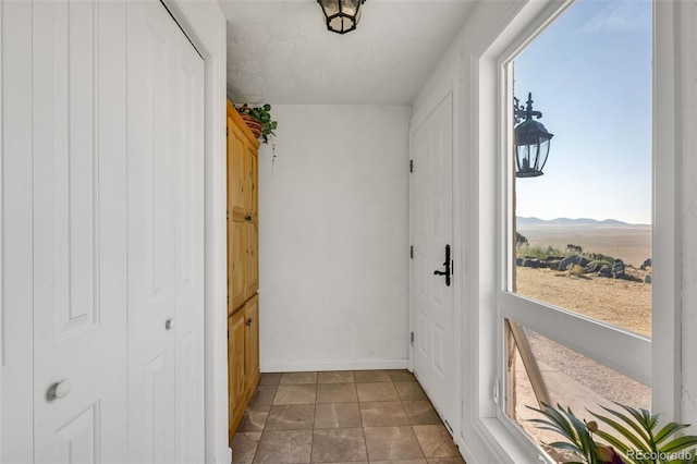 doorway to outside featuring a mountain view