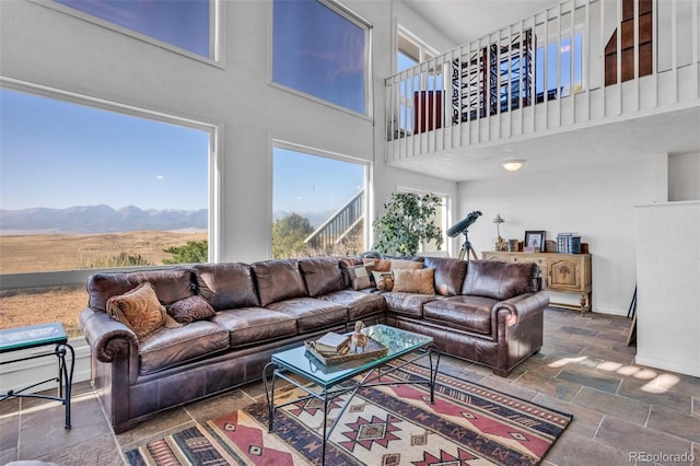 living room featuring a high ceiling and a mountain view