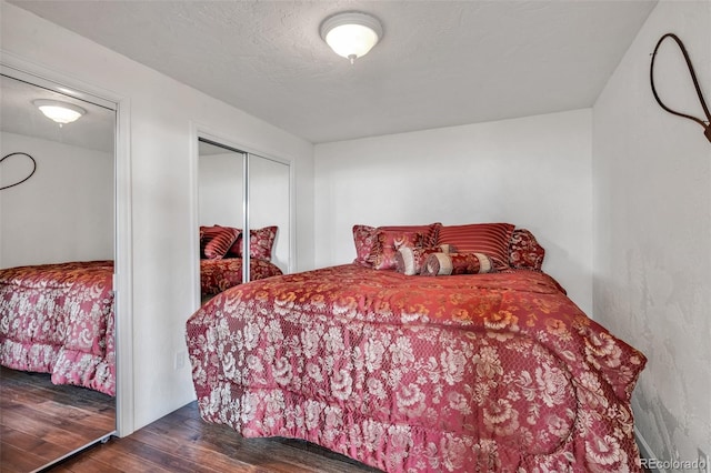 bedroom with a closet and dark hardwood / wood-style floors