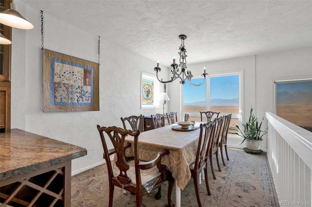 dining area with a chandelier and a textured ceiling