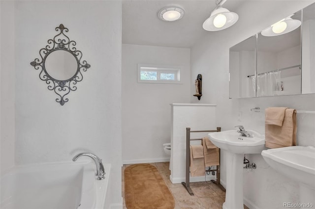 bathroom with sink, toilet, and tile patterned floors