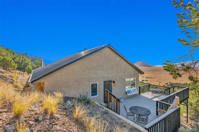 back of house with a deck with mountain view