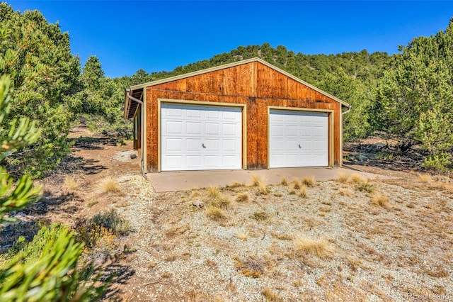 garage featuring wood walls