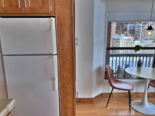 kitchen featuring light wood-type flooring and white refrigerator