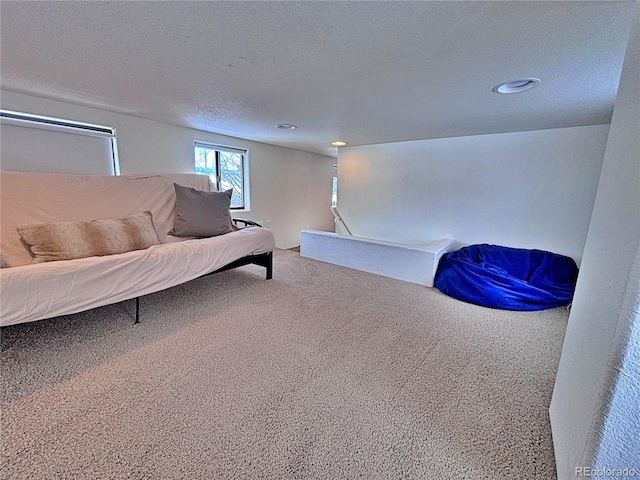 carpeted living room featuring a textured ceiling