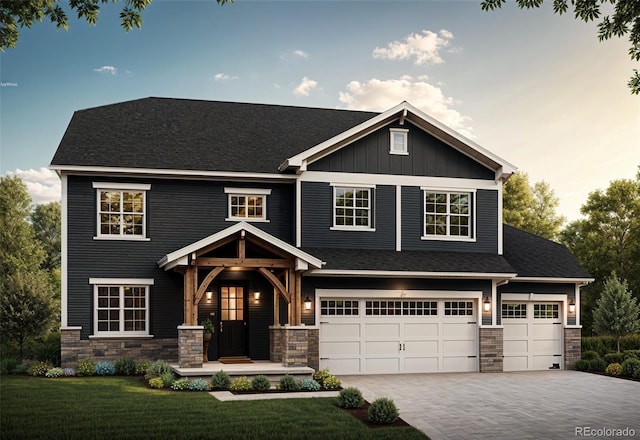 craftsman-style house featuring a garage and a front yard