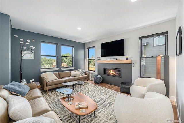 941 Saint Andrews Ln, Louisville, CO 80027 - living area with wood finished floors, a tiled fireplace, and recessed lighting