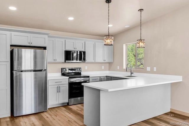 388 14th Trl, Cotopaxi, CO 81223 - kitchen with appliances with stainless steel finishes, a sink, a chandelier, a peninsula, and light countertops