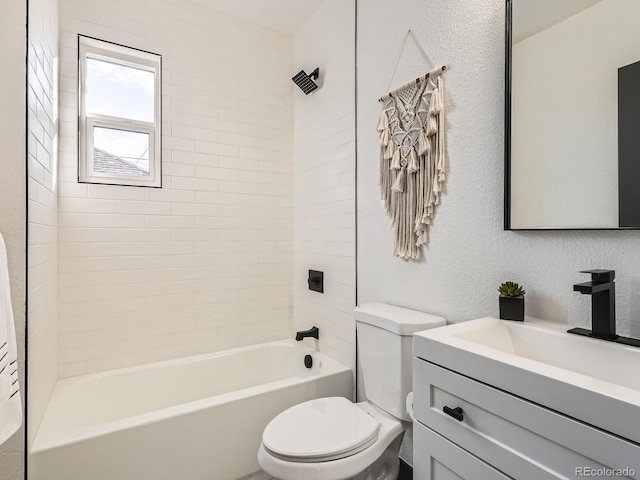 bathroom with toilet, a textured wall,  shower combination, and vanity