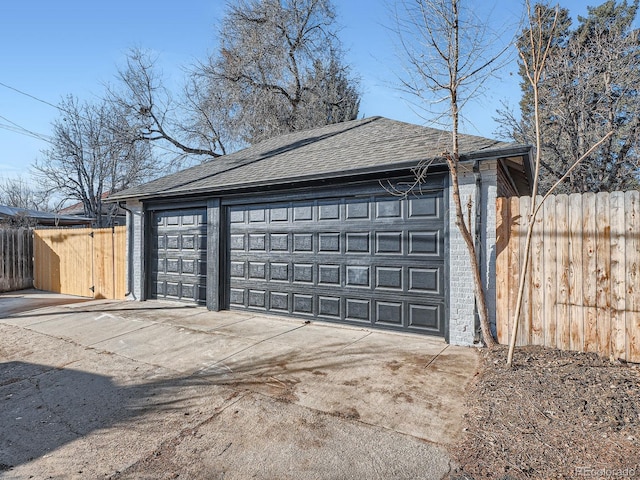 detached garage featuring fence