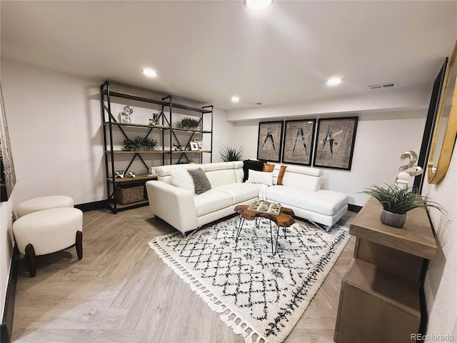 living room with recessed lighting, visible vents, and baseboards