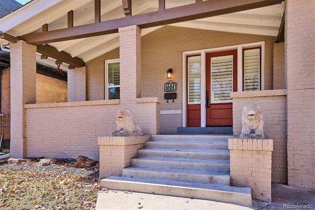 view of exterior entry with brick siding