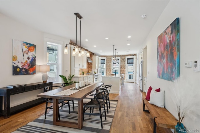 dining area featuring light wood-type flooring, plenty of natural light, and recessed lighting