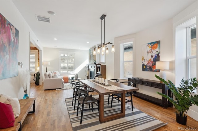 dining room featuring light wood-style flooring, visible vents, and recessed lighting