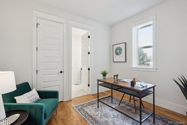 office space featuring light wood-style flooring and baseboards