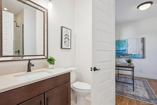 full bathroom featuring walk in shower, vanity, toilet, and wood finished floors