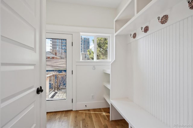 mudroom with wood finished floors and baseboards