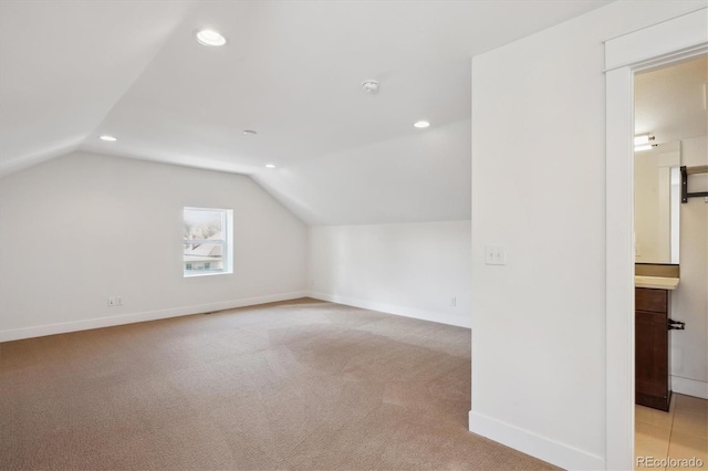 bonus room with lofted ceiling, recessed lighting, light carpet, and baseboards