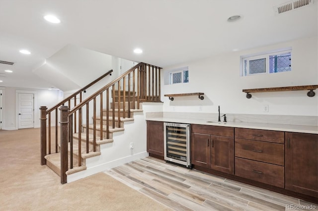 bar with beverage cooler, a sink, visible vents, and recessed lighting