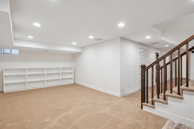 finished basement featuring recessed lighting, visible vents, baseboards, and stairs