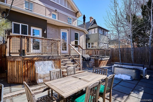 view of patio featuring an outdoor hangout area, outdoor dining space, and fence