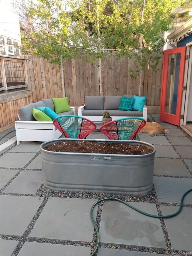 view of patio / terrace featuring fence and an outdoor hangout area