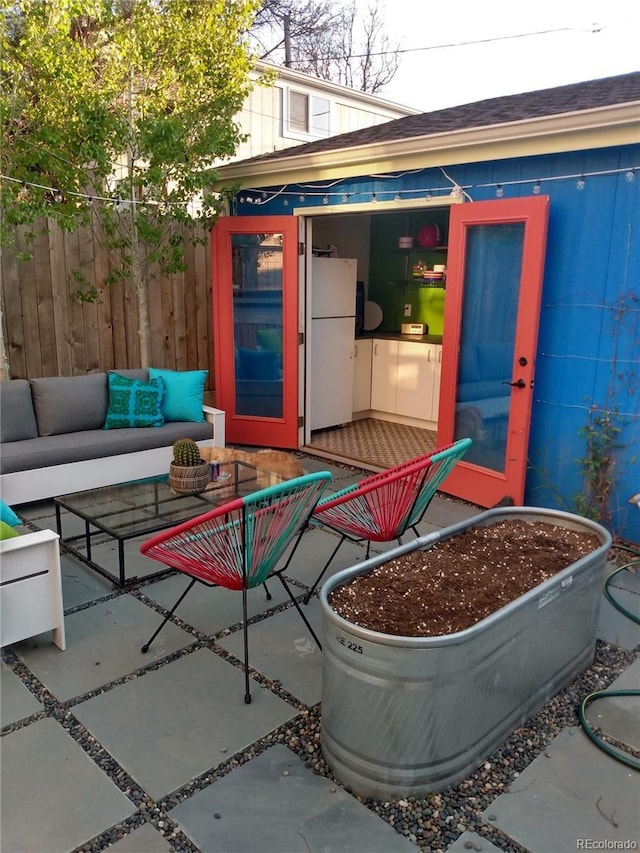 view of patio featuring outdoor lounge area and fence