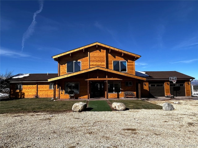 back of house featuring a garage