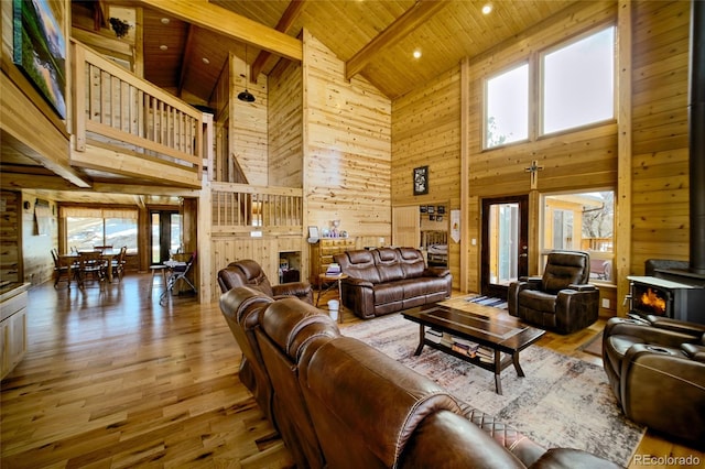 living room with beam ceiling, hardwood / wood-style floors, high vaulted ceiling, and wood ceiling