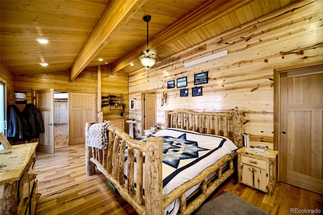 bedroom with vaulted ceiling with beams, wooden ceiling, wooden walls, and light hardwood / wood-style floors