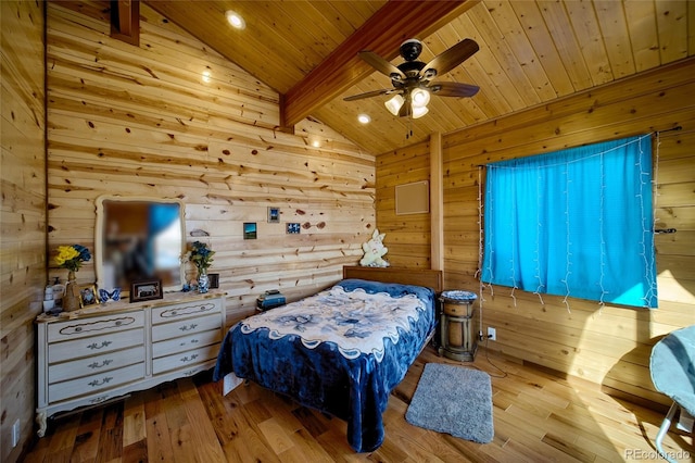 bedroom featuring ceiling fan, lofted ceiling with beams, wooden walls, wood ceiling, and light wood-type flooring