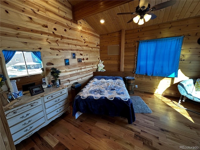 bedroom with ceiling fan, wooden ceiling, wood walls, hardwood / wood-style floors, and vaulted ceiling