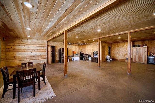 basement with black refrigerator with ice dispenser, wood ceiling, and wood walls