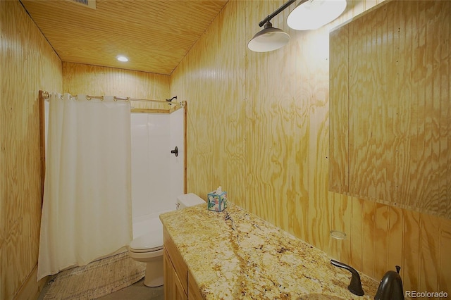 bathroom featuring a shower with shower curtain, toilet, and wood walls