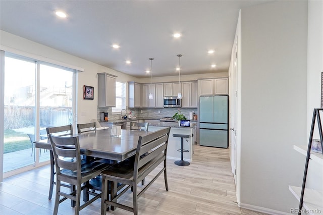 9448 Richfield St, Commerce City, CO 80022 - dining room with light wood-type flooring, recessed lighting, and baseboards